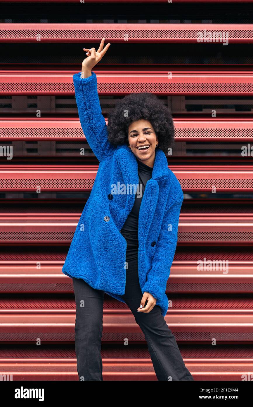 Stock photo of cheerful african american girl posing and looking at ...