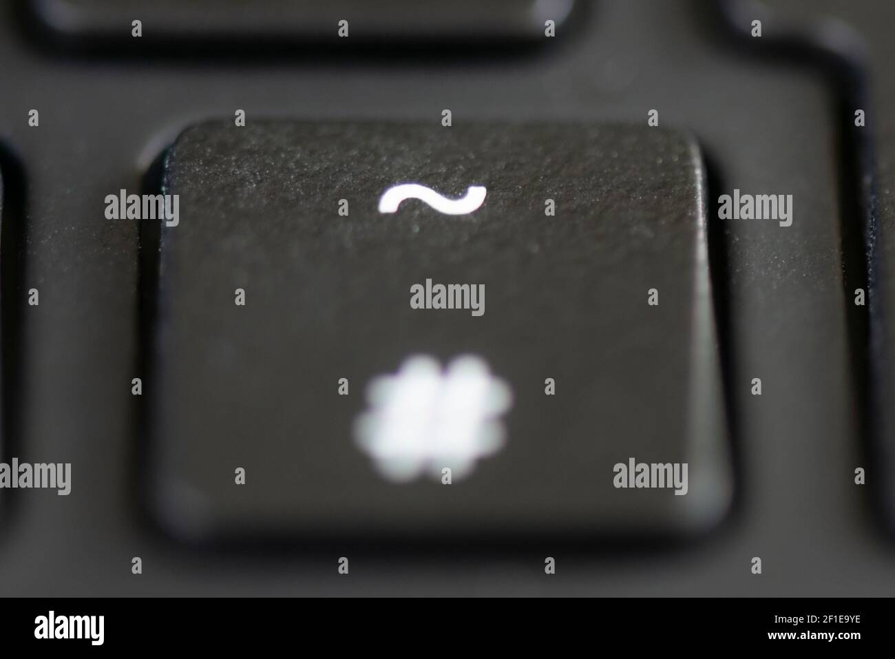 The hash and tilde key on a laptop keyboard Stock Photo - Alamy