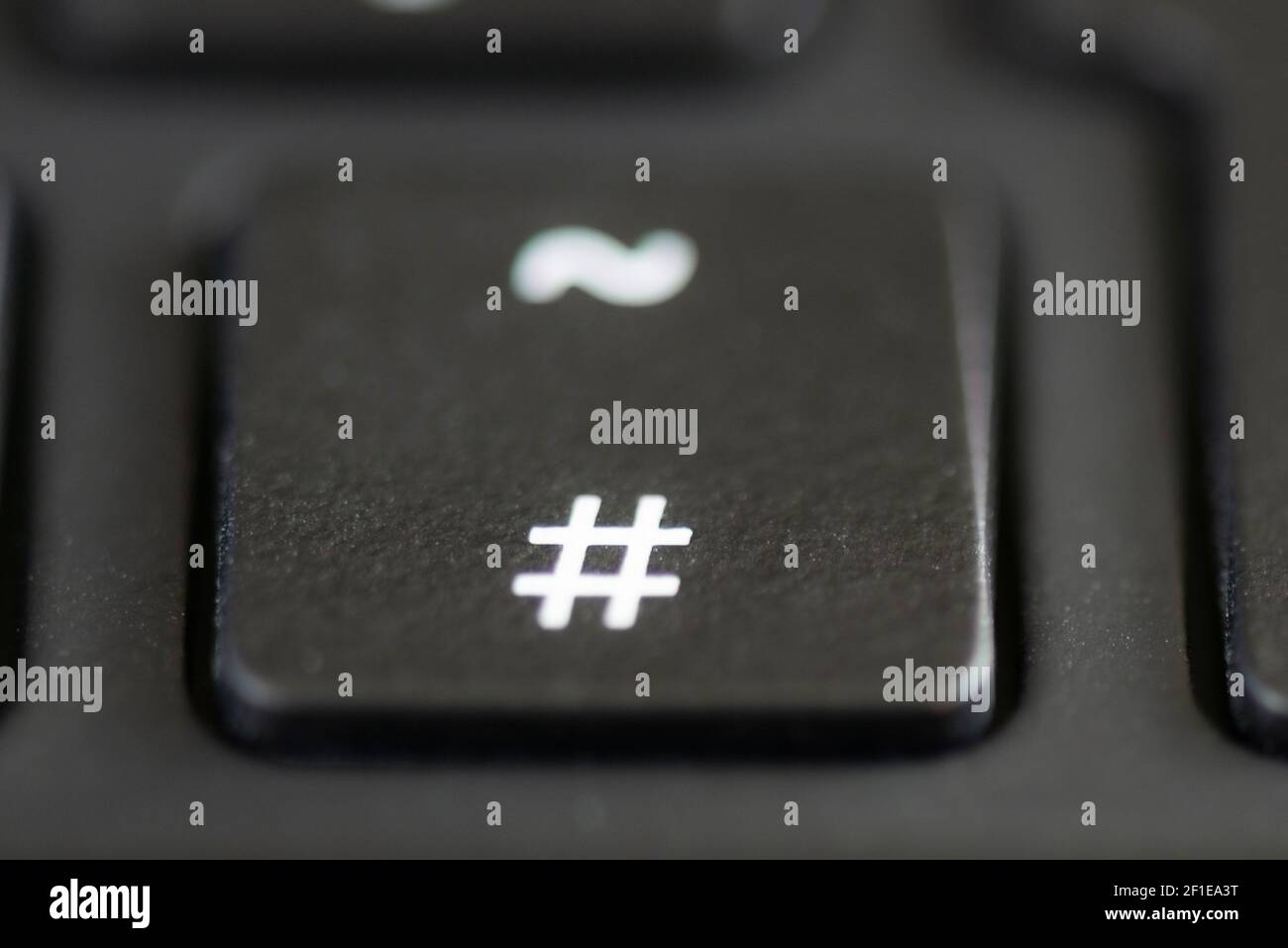 The hash and tilde key on a laptop keyboard Stock Photo - Alamy
