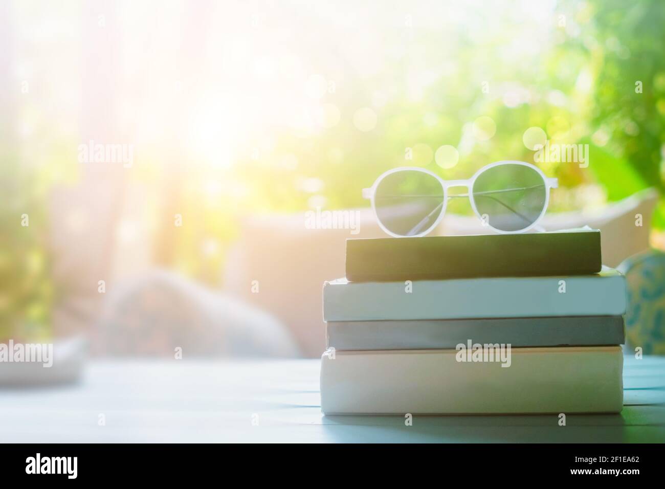 Books on table with sunglasses on top in resort room on vacation in