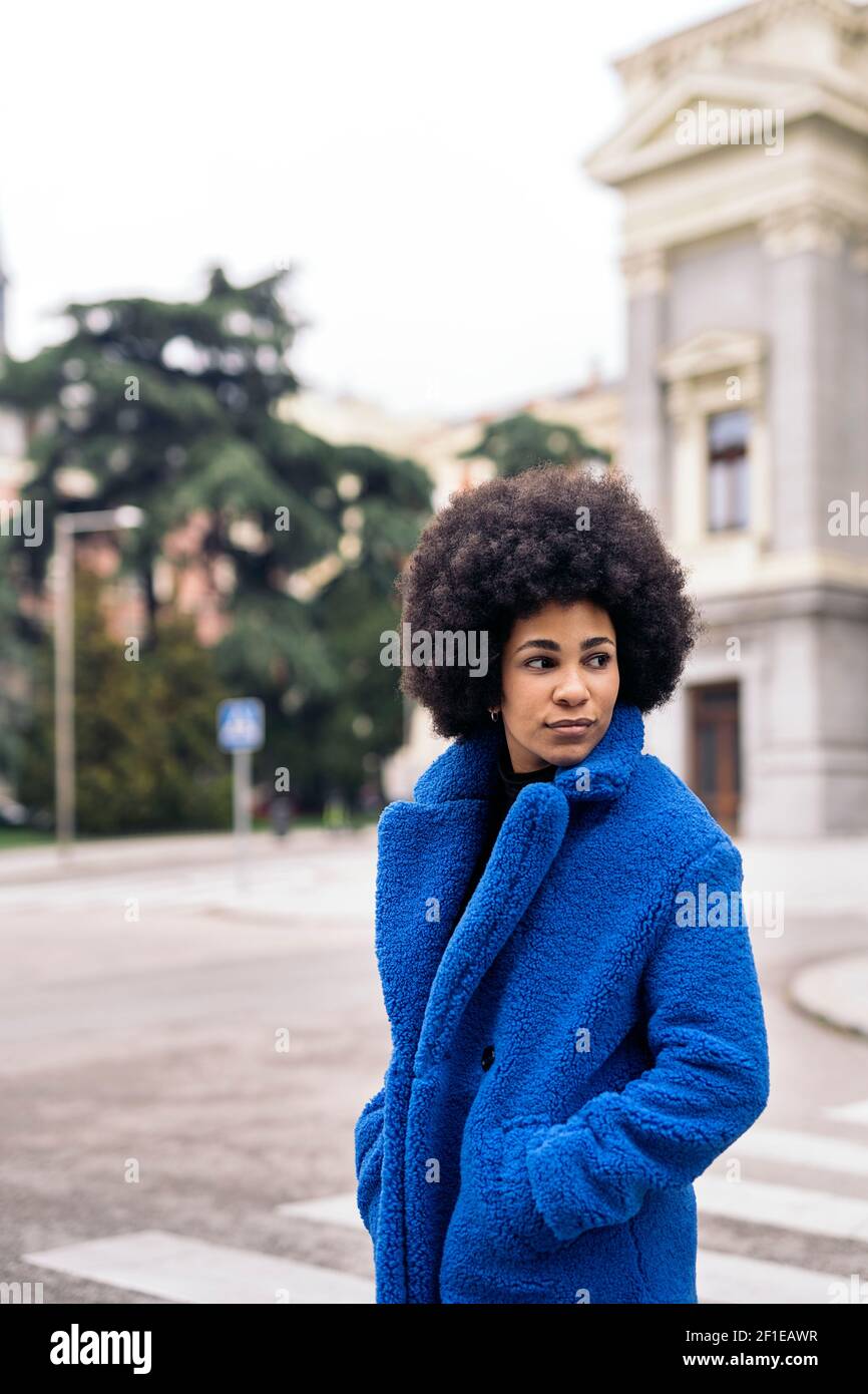 Stock photo of young afro woman with expressive look walking in the ...