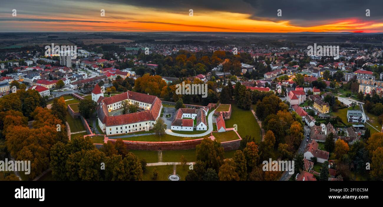 Sarvar, Hungary - Aerial panoramic view of the Castle of Sarvar (Nadasdy castle) with Sarvar Arboretum, a beautiful dramatic sunrise and rain clouds a Stock Photo