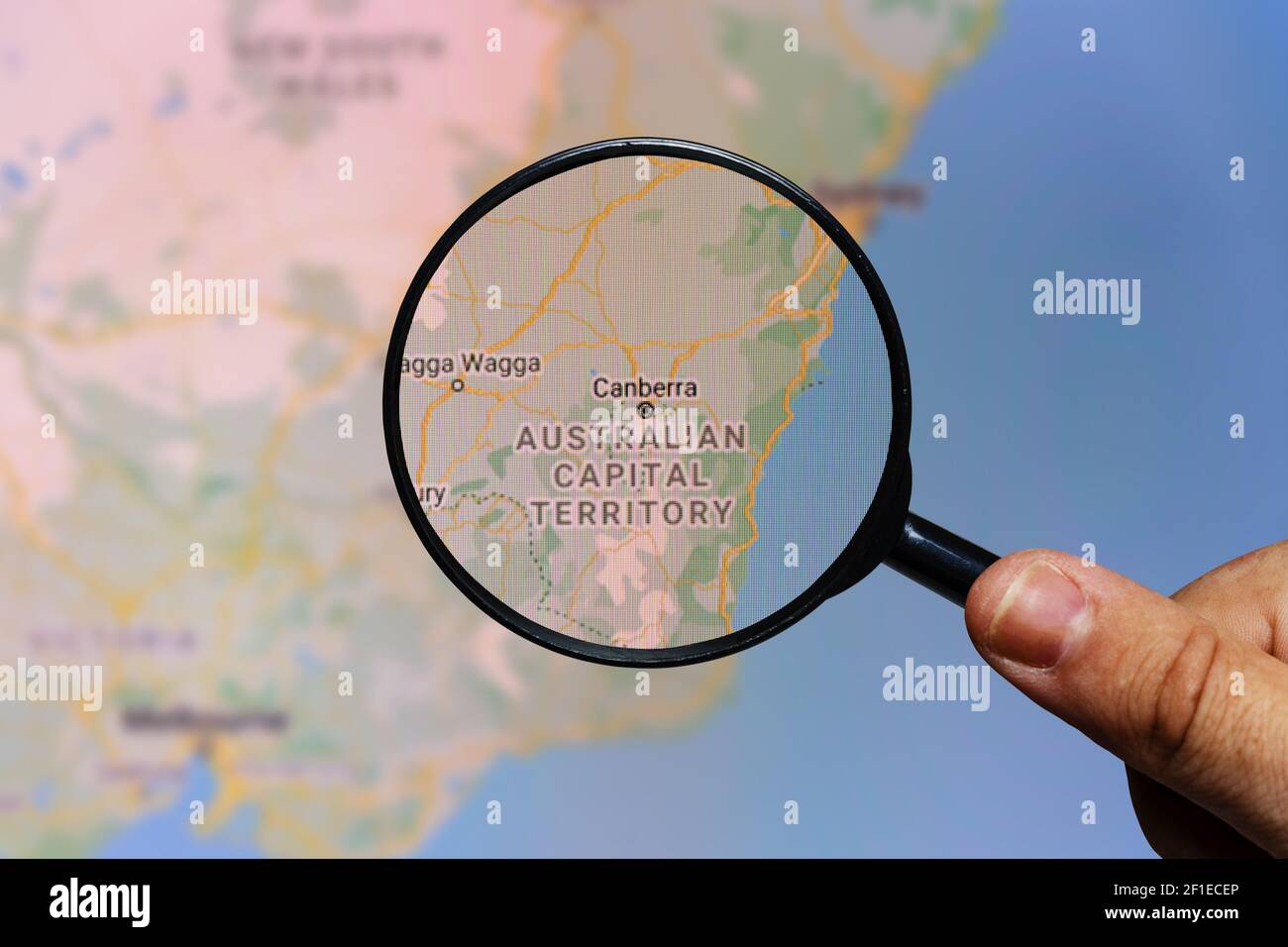 Moscow, Russia - March 07, 2021: Canberra city in Australia on a monitor screen through a magnifying glass. Stock Photo
