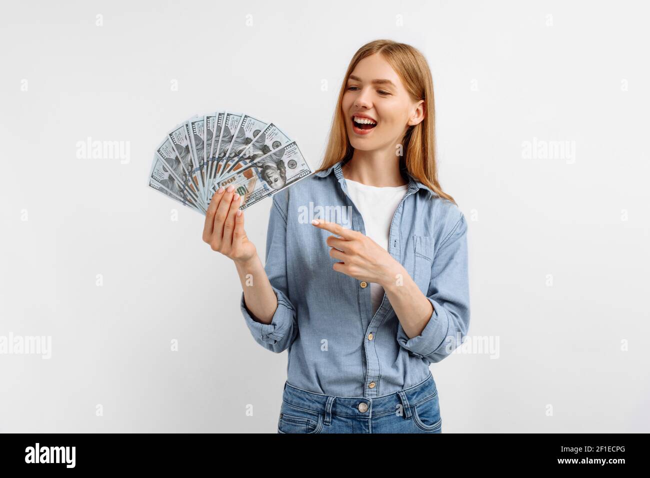 Image of happy excited young woman showing pile of money banknotes, US ...