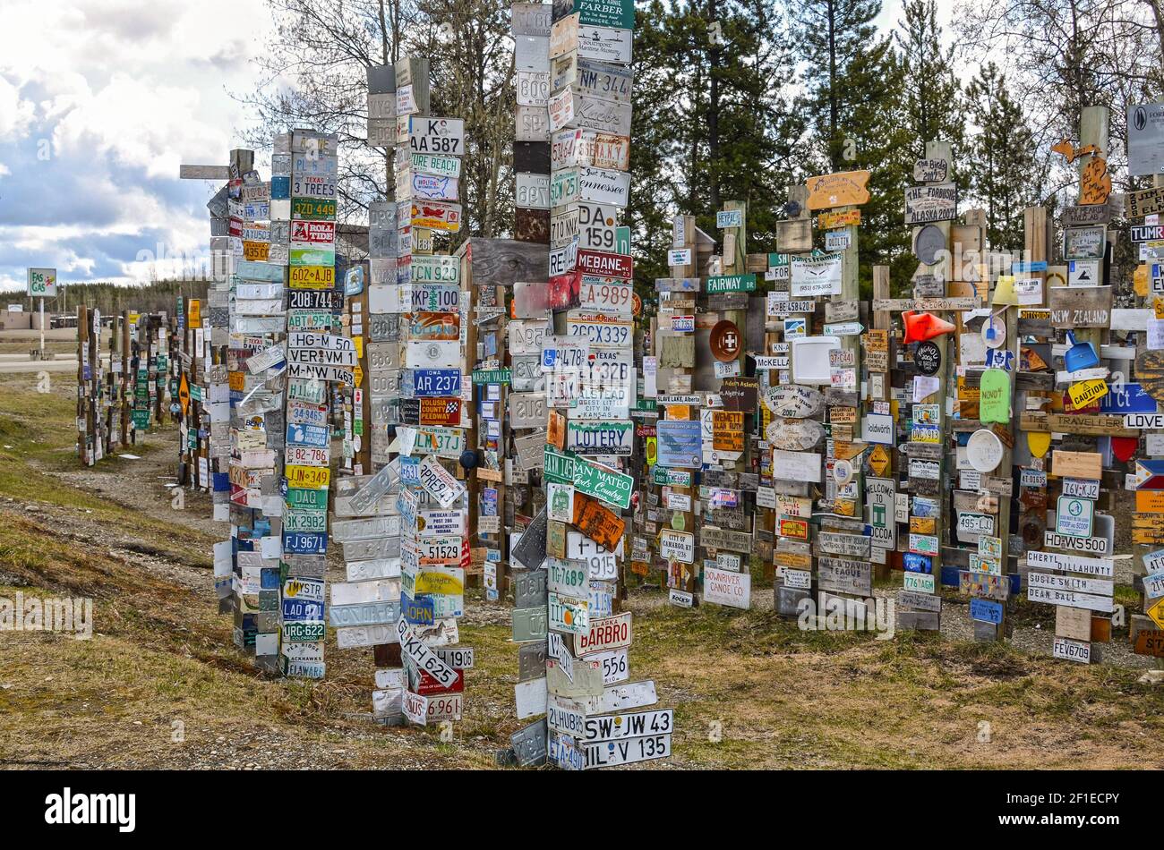 WATSON LAKE, YUKON, CANADA - MAY 19, 2012: The Sign Post Forest is a famous attraction of Watson Lake on the Alaska Highway. Stock Photo