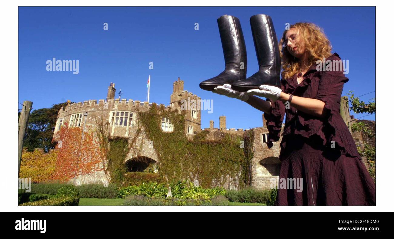 The Duke of Wellingtons Boots are one of the artefacts seen at Walmer Castle in an exhibition marking the 150 th anniversity of his death on at Walmer Castle 14 aug to 2 Nov 2002.Curator Rowena Shepherd with bootspic David Sandison 14/8/2002 Stock Photo