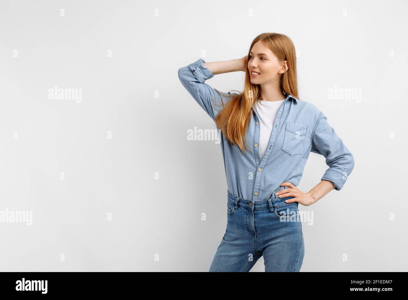 Beautiful happy young woman posing and looking at camera on white ...