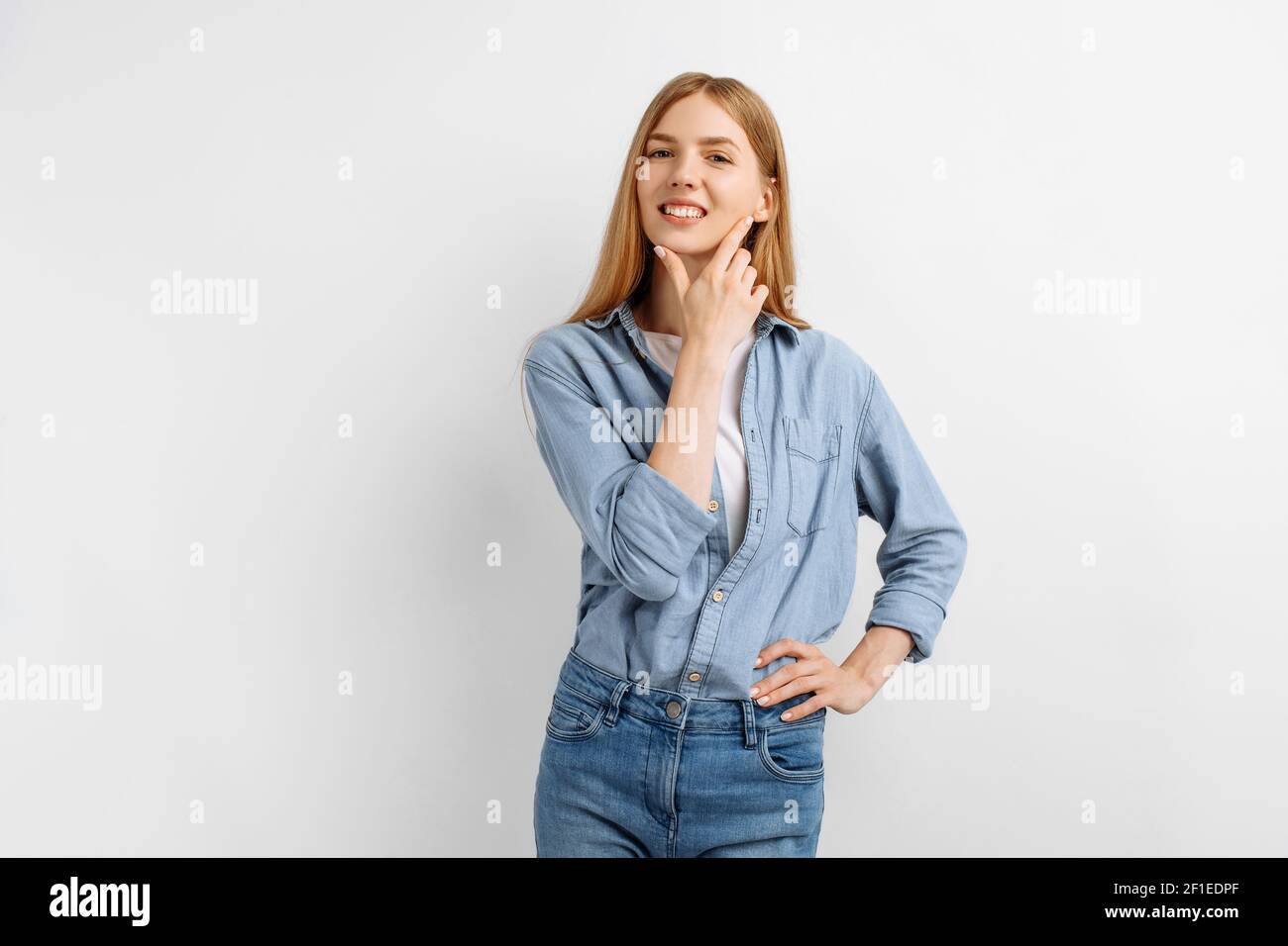 Beautiful happy young woman posing and looking at camera on white ...