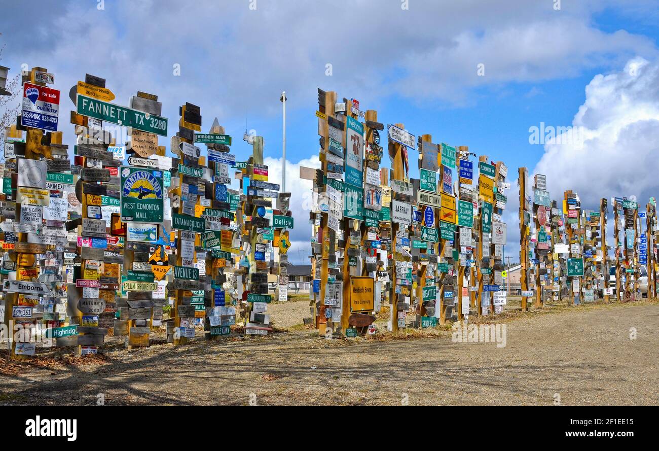 WATSON LAKE, YUKON, CANADA - MAY 19, 2012: The Sign Post Forest is a famous attraction of Watson Lake on the Alaska Highway. Stock Photo