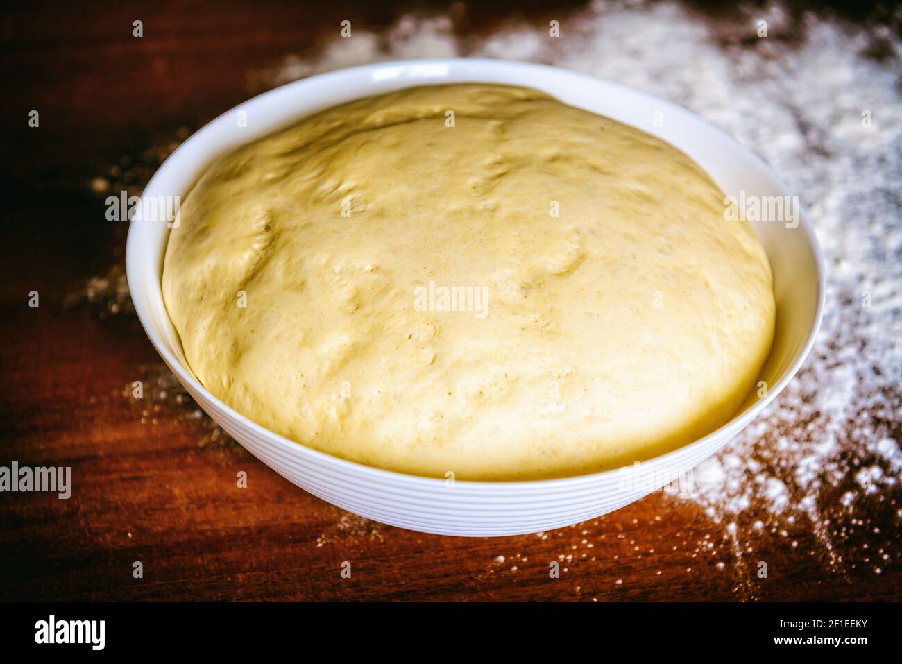 Preparing dough for white bread, rolls, pizza. Yeast dough in a bowl