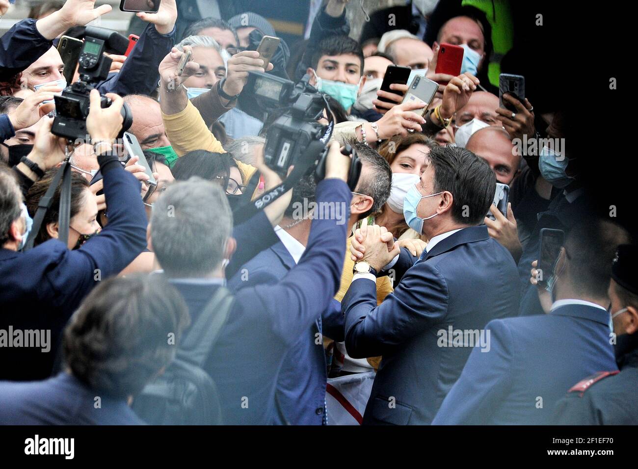 Giuseppe Conte President of the Council of Ministers of the Italian Republic wearing an anti-coronavirus mask, while meeting the citizens of the city Stock Photo