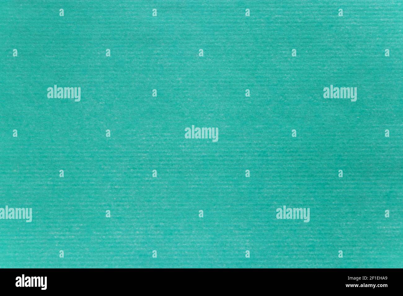 Turquoise green tinted paper texture closeup. Horizontal straped sheet. Stock Photo