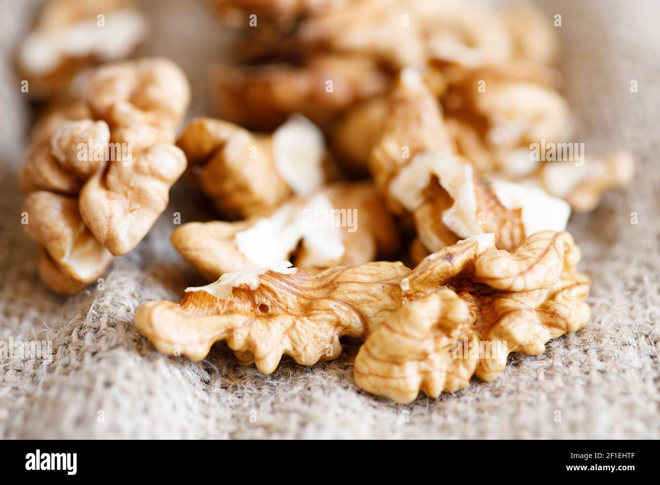 peeled walnuts lie in a heap on sacking. High quality photo Stock Photo