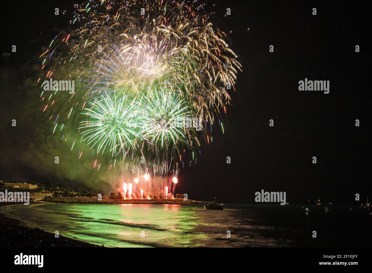 Fireworks display over sea with reflections Stock Photo