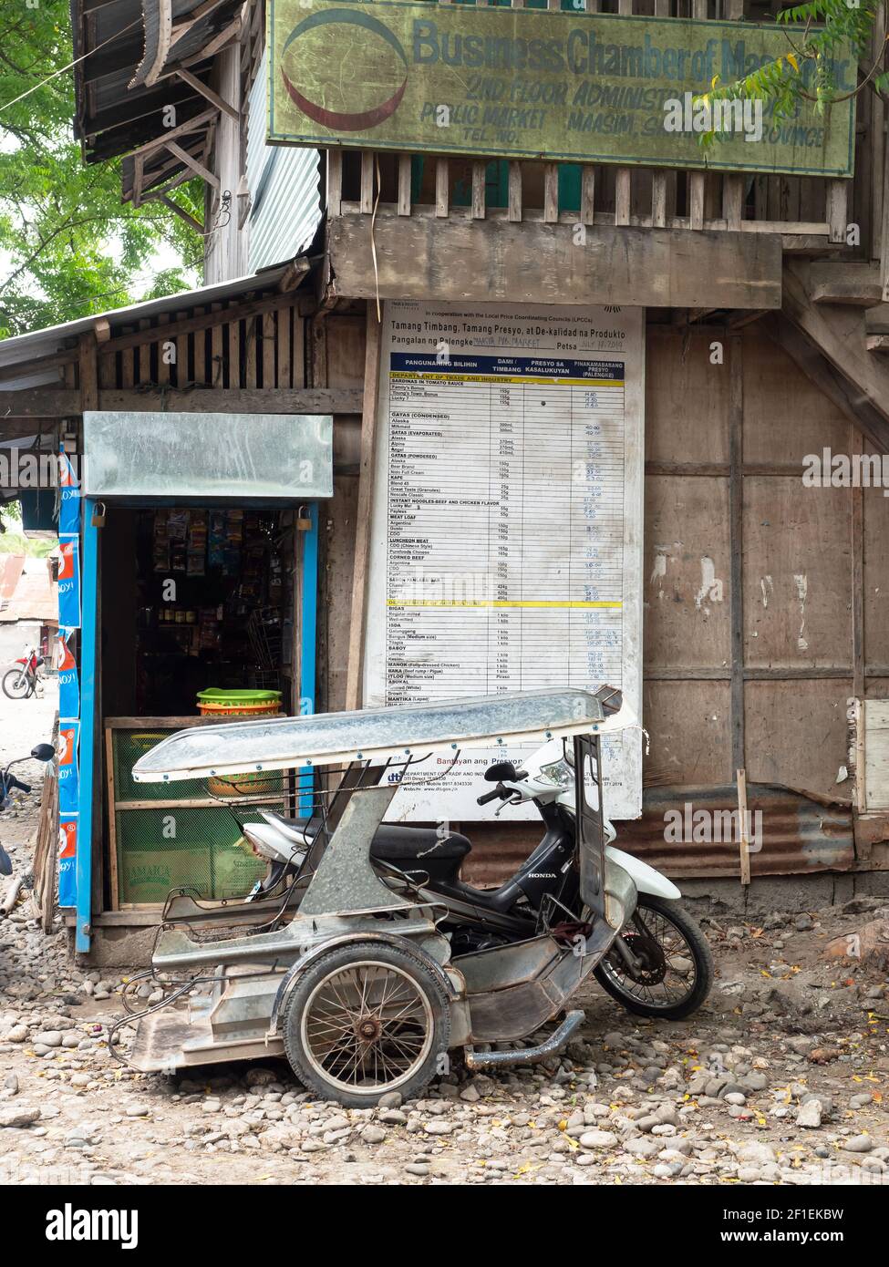 Tricycle taxi parked outside a shop at Maasim Public Market in the Sarangani Province of the Philippines. Maasim is located at the southernmost part o Stock Photo