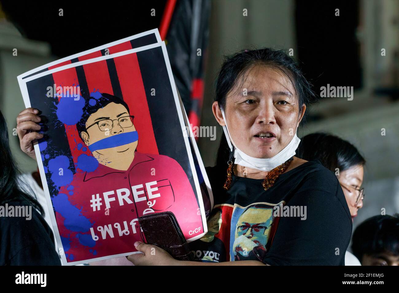 Sureerat Chiwarak holding a portrait of her son, Parit 'Penguin' Chivarak, during the demonstration. A group of protestors led by Jatupat 'Pai' Boonpattararaksa, one of the Thai pro-democracy leaders arrives at the Democracy monument while protesting against the imprisonment of 4 pro-democracy activists (Somyot Pruksakasemsuk, Patiwat Saraiyam, Parit 'Penguin' Chivarak, and Anon Nampa) who were arrested under the lese majeste law (Article 112 of the Thai criminal code) and demand the reform of the monarchy and abolition of the lese-majesty law. Stock Photo