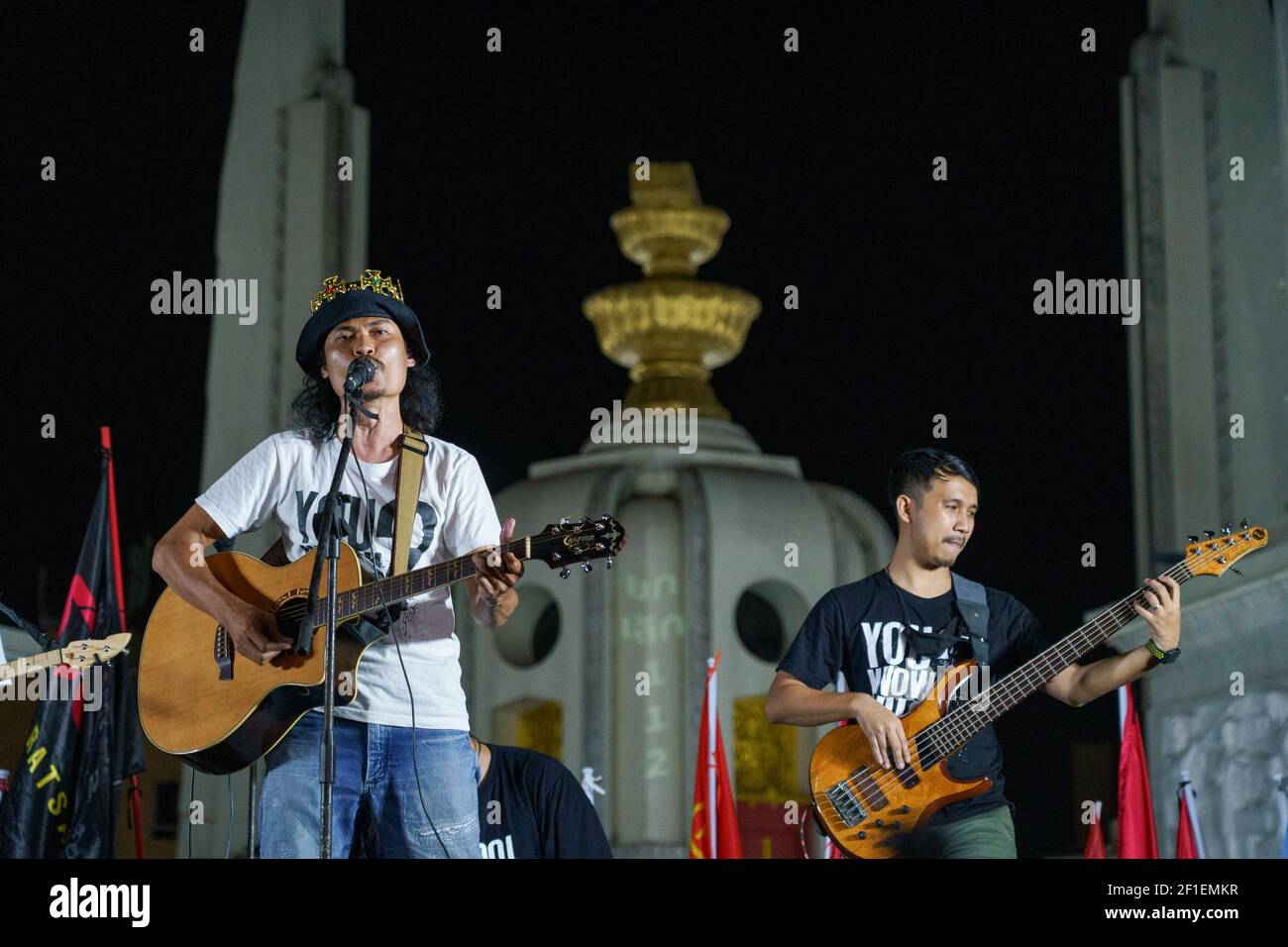 'Commoners Band' doing a live performance in front of Democracy monument during the demonstration. A group of protestors led by Jatupat 'Pai' Boonpattararaksa, one of the Thai pro-democracy leaders arrives at the Democracy monument while protesting against the imprisonment of 4 pro-democracy activists (Somyot Pruksakasemsuk, Patiwat Saraiyam, Parit 'Penguin' Chivarak, and Anon Nampa) who were arrested under the lese majeste law (Article 112 of the Thai criminal code) and demand the reform of the monarchy and abolition of the lese-majesty law. Stock Photo