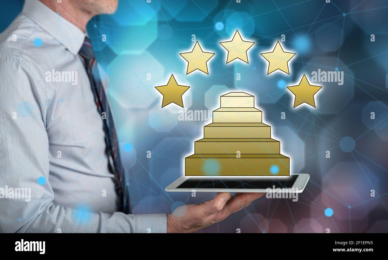 Quality concept above a tablet held by a man Stock Photo