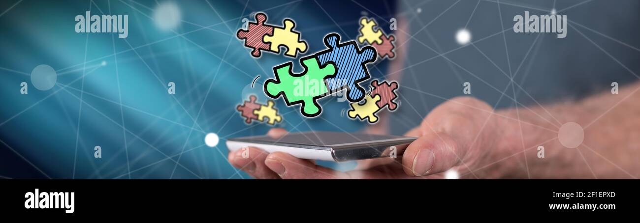 Teamwork concept above a smartphone held by a man Stock Photo - Alamy