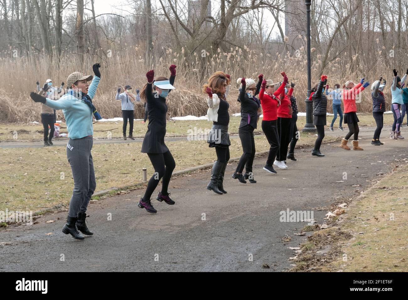 On a winter morning, Asian American women, primarily Chinese, attend a dance exercise class in a park in Flushing, Queens, New York City. Stock Photo