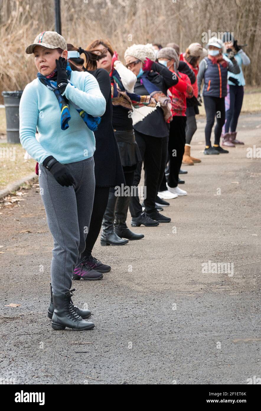 On a winter morning, Asian American women, primarily Chinese, attend a dance exercise class in a park in Flushing, Queens, New York City. Stock Photo