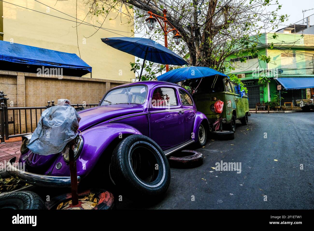 An old Volksagen Beetle stands in a street in the Chinatown are of Bangkok, Thailand Stock Photo