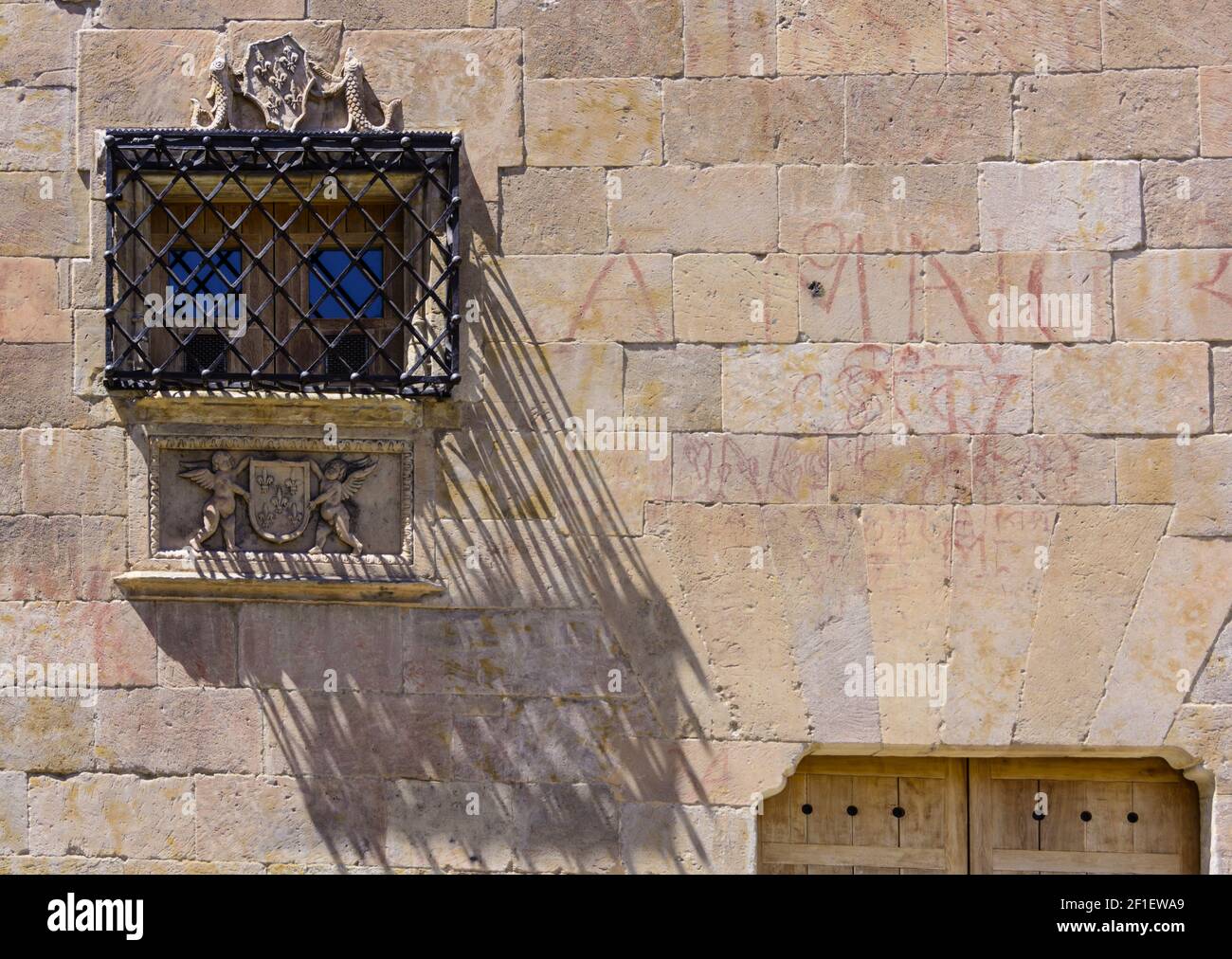 Window with bars on Facade of the Casa de las Conchas in Salamanca