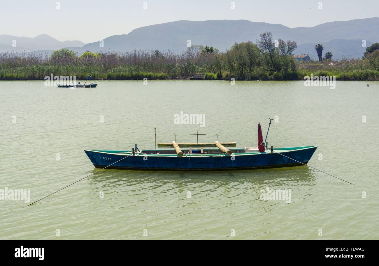 Calm lake with fishing boats. Fresh water lagoon in Estany de cullera. Valencia, Spain Stock Photo