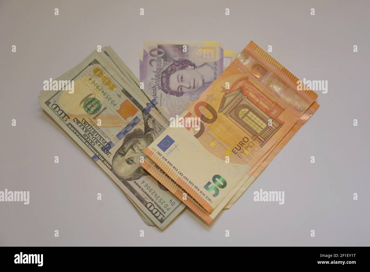 A selection of UK pound sterling, Euro and US dolar banknotes on a white background Stock Photo