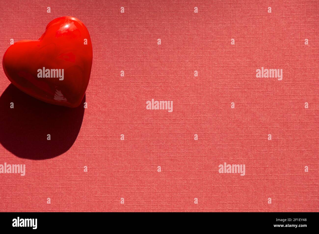 lovely Happy Valentines day concept with red heart shape on red paper sheet Stock Photo