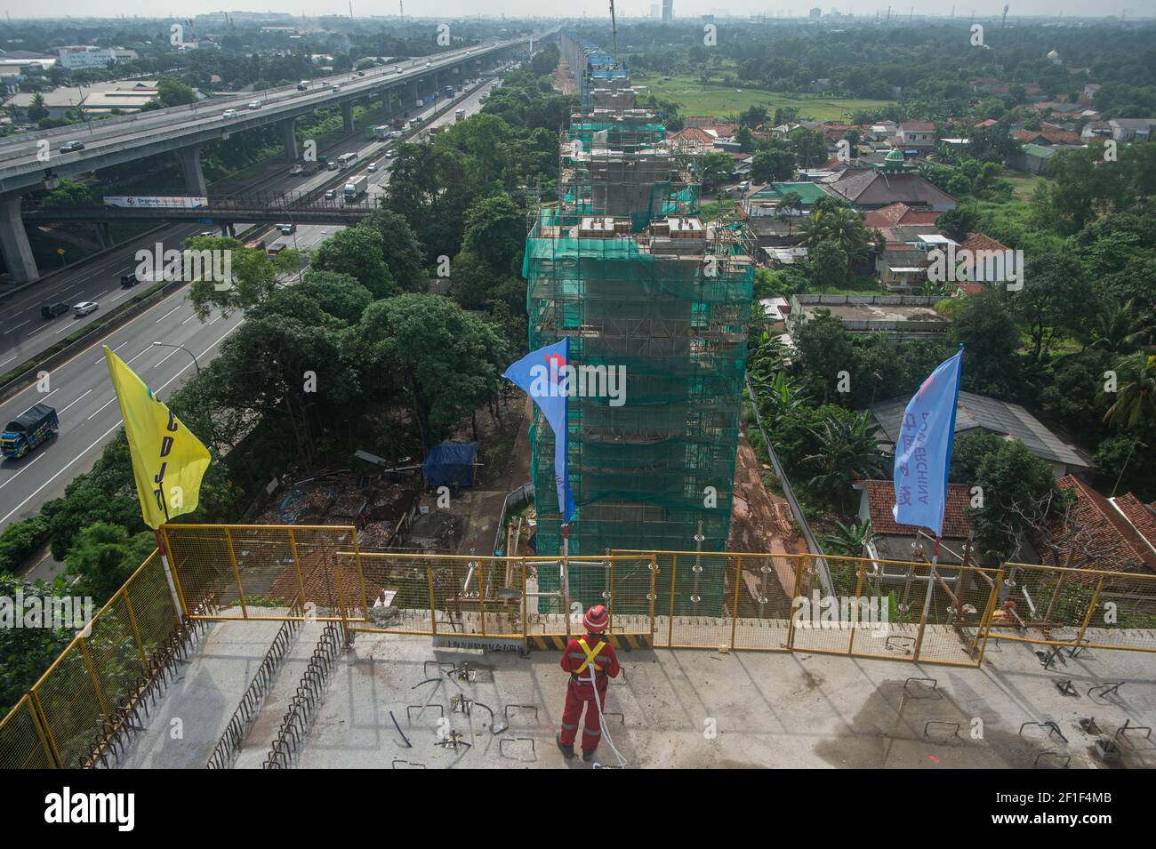 Jakarta, Indonesia. 08th Mar, 2021. A worker stands on the largest span continuous beam of the Jakarta-Bandung High Speed Railway in Bekasi of Indonesia on March 8, 2021. The continuous beam with the largest span of Jakarta-Bandung High-Speed Railway (HSR) was successfully closed on Monday morning, marking the significant progress of another critical control project in the construction of the railway. A statement released by KCIC, a joint venture consortium by Chinese and Indonesian state-owned firms that runs the 142. Credit: Xinhua/Alamy Live News Stock Photo