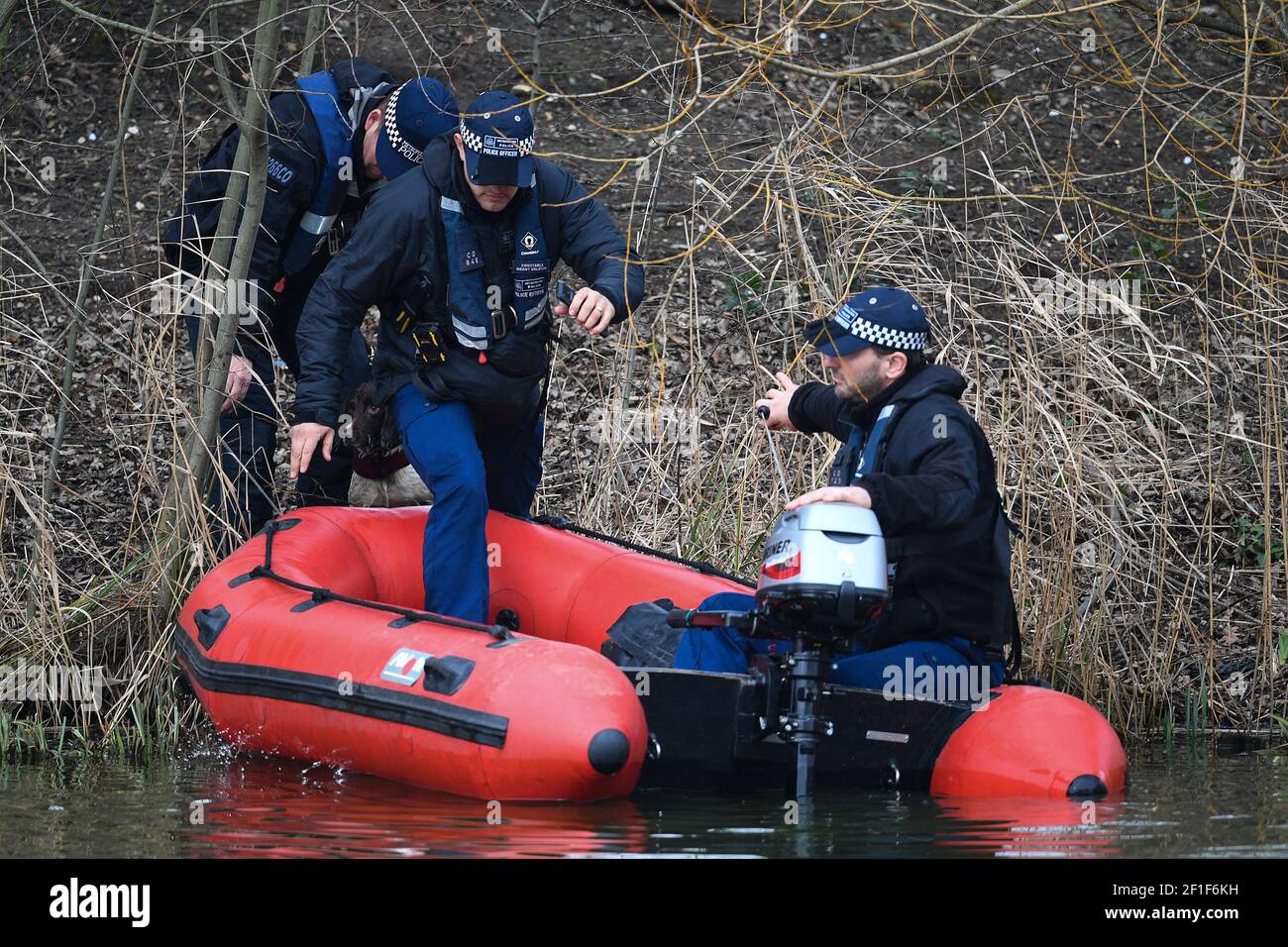 Police in a boat with a sniffer dog search Mount Pond on Clapham Common for missing woman Sarah Everard, 33, who left a friend's house in Clapham, south London, on Wednesday evening at around 9pm and began walking home to Brixton. Picture date: Monday March 8, 2021. Stock Photo