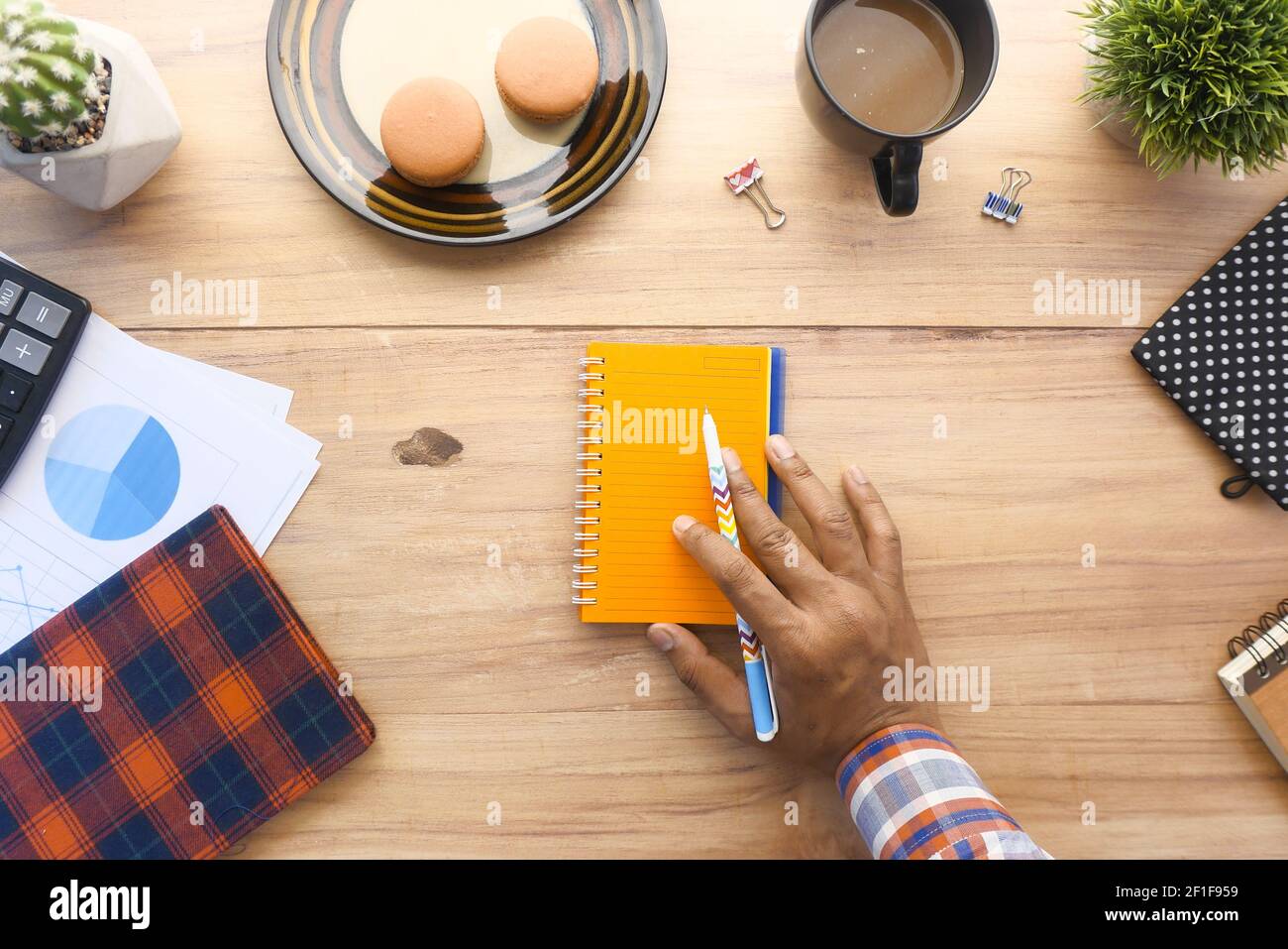 top view of man hand writing on notepad on office desk Stock Photo - Alamy