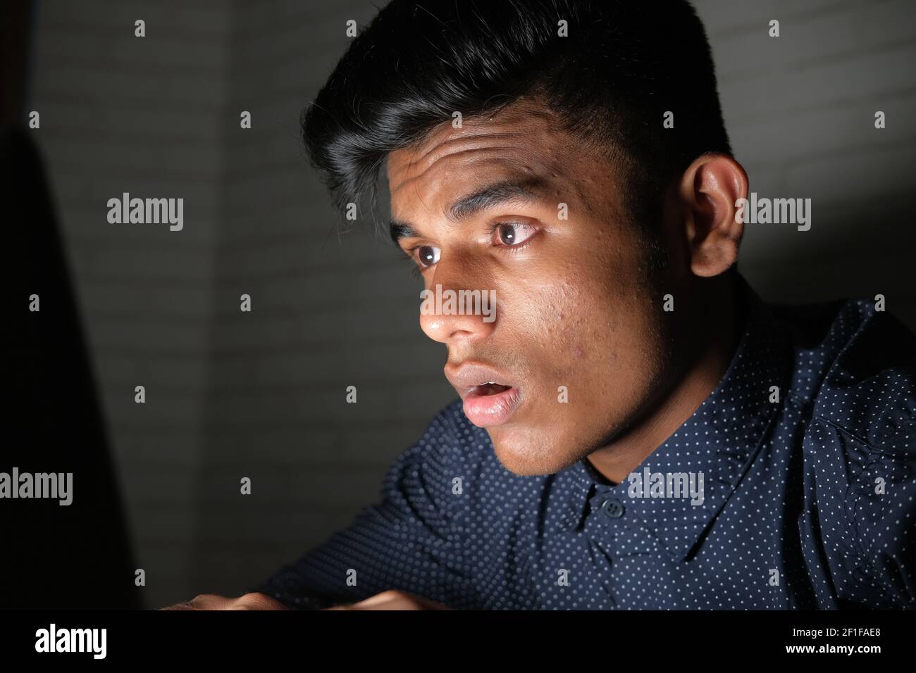 young man working on laptop stealing personal data  Stock Photo