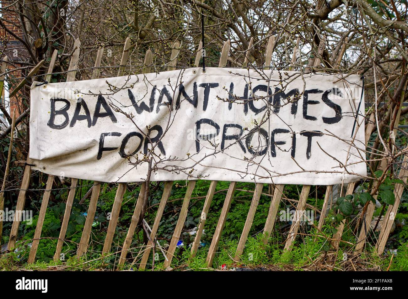Sipson, UK. 8th March, 2021. A BBA Want Homes for Profit banner outside a house in Sipson. The fight by local residents and environmentalists to the stop the third runway at London Heathrow continues. Last year the Supreme Court reversed a decision to stop plans for a third runway at Heathrow Airport. Developers are now able to seek planning permission for the controversial third runway. Not only would the number of flights from London Heathrow increase dramatically but they would be flying at lower heights causing more noise and pollution to residents. Credit: Maureen McLean/Alamy Stock Photo