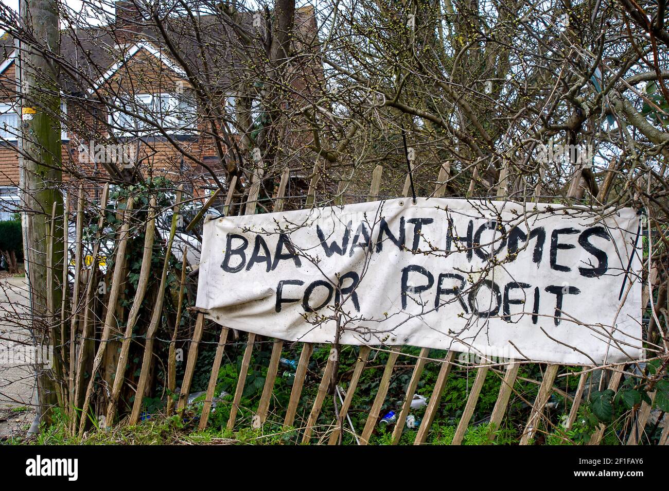 Sipson, UK. 8th March, 2021. A BBA Want Homes for Profit banner outside a house in Sipson. The fight by local residents and environmentalists to the stop the third runway at London Heathrow continues. Last year the Supreme Court reversed a decision to stop plans for a third runway at Heathrow Airport. Developers are now able to seek planning permission for the controversial third runway. Not only would the number of flights from London Heathrow increase dramatically but they would be flying at lower heights causing more noise and pollution to residents. Credit: Maureen McLean/Alamy Stock Photo