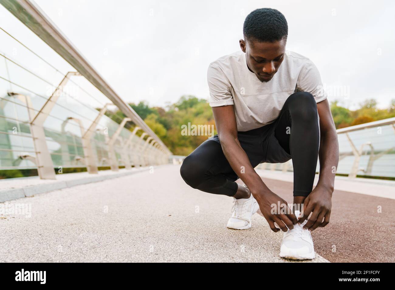 Picture of African athlete tying shoelaces hi-res stock photography and images - Alamy