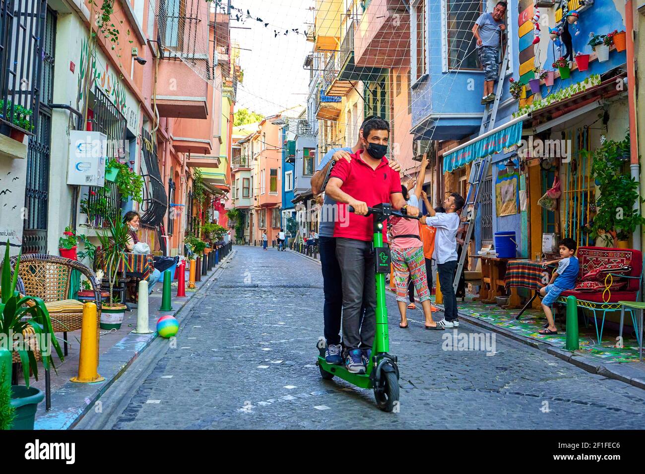 Ordinary life in the old district of Istanbul. two guys are riding along a  narrow street on one electric scooter. Turkey , Istanbul - 21.07.2020 Stock  Photo - Alamy