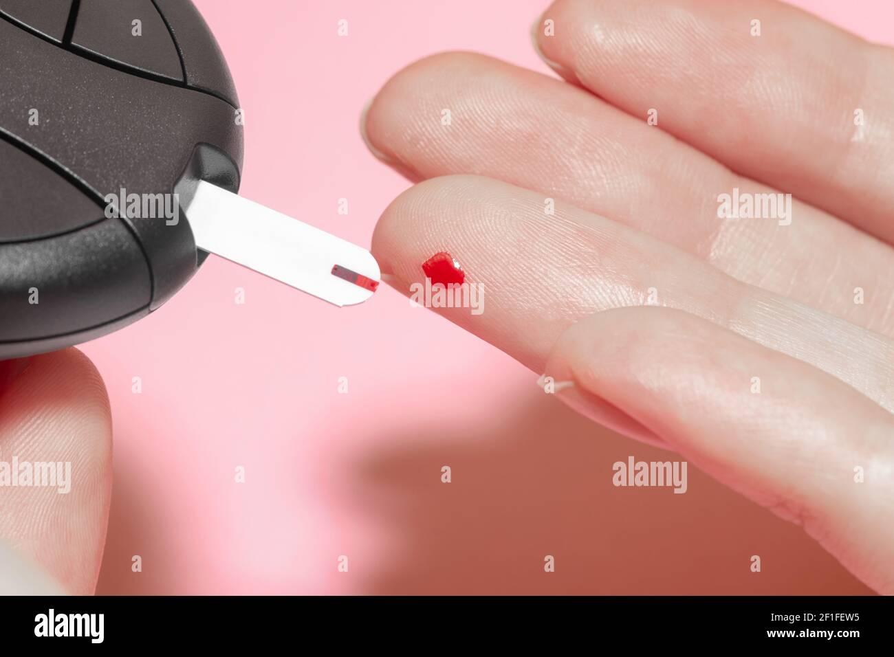 Health care concept. Closeup view of woman fingers doing blood test for sugar level (glucose