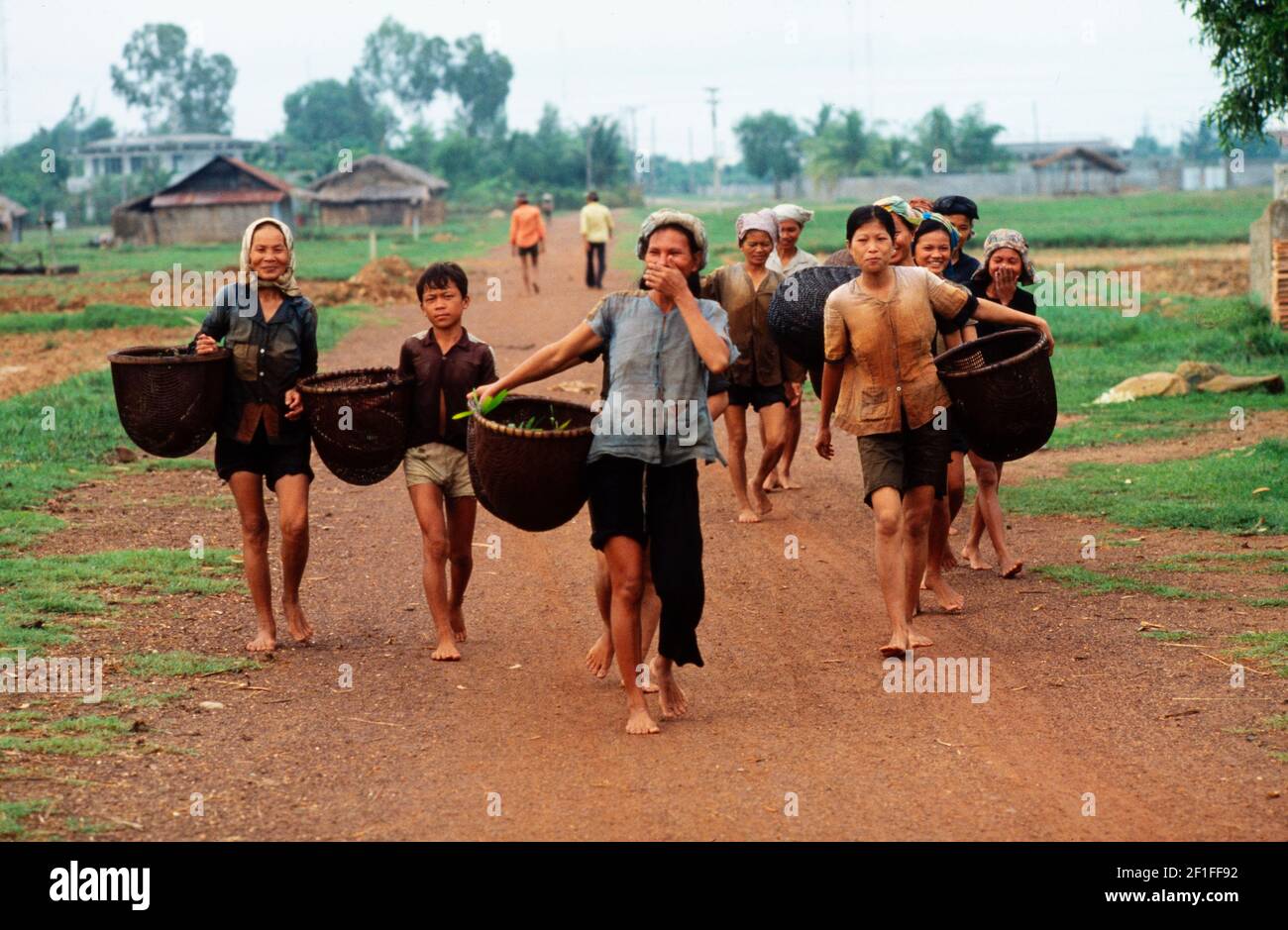 Villagers on their way to fish in the local river with their fishing baskets, rural South Vietnam, June 1980 Stock Photo