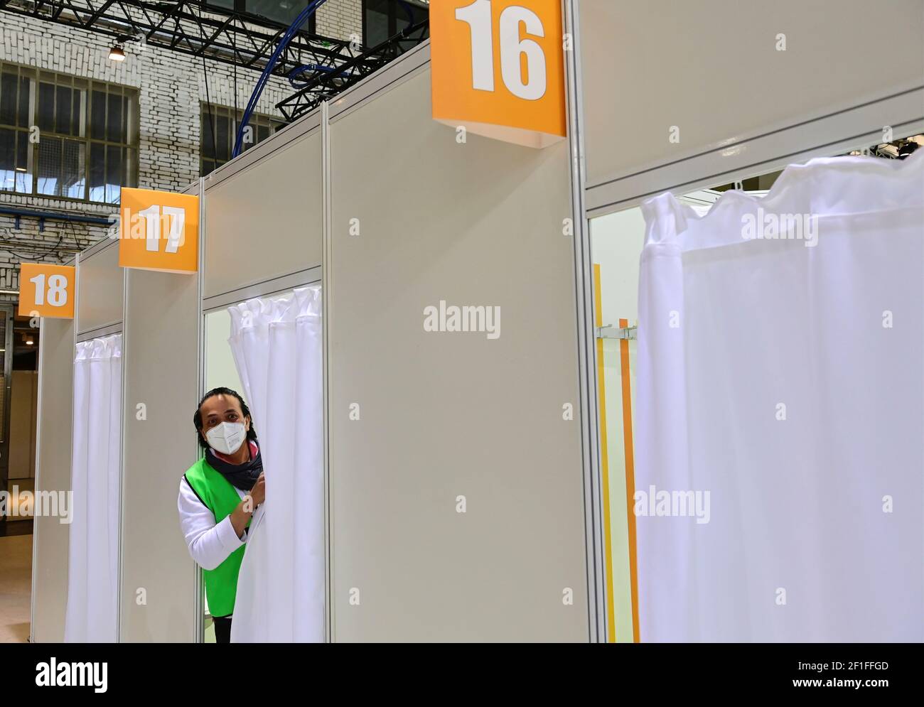 A health worker looks out of a cabin at a new Covid-19 vaccination centre inside the former Tempelhof airport in Berlin, Germany March 8, 2021. Tobias Schwarz/Pool via REUTERS Stock Photo