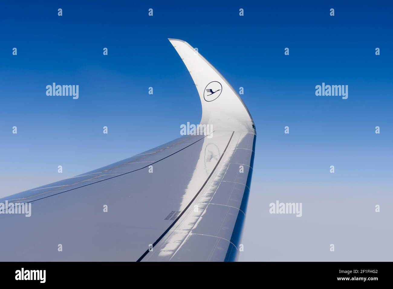 Curved wingtips design of Airbus A350 wing, also know as sharklets. Wingtip of Lufthansa Airlines modern aircraft in flight. Stock Photo