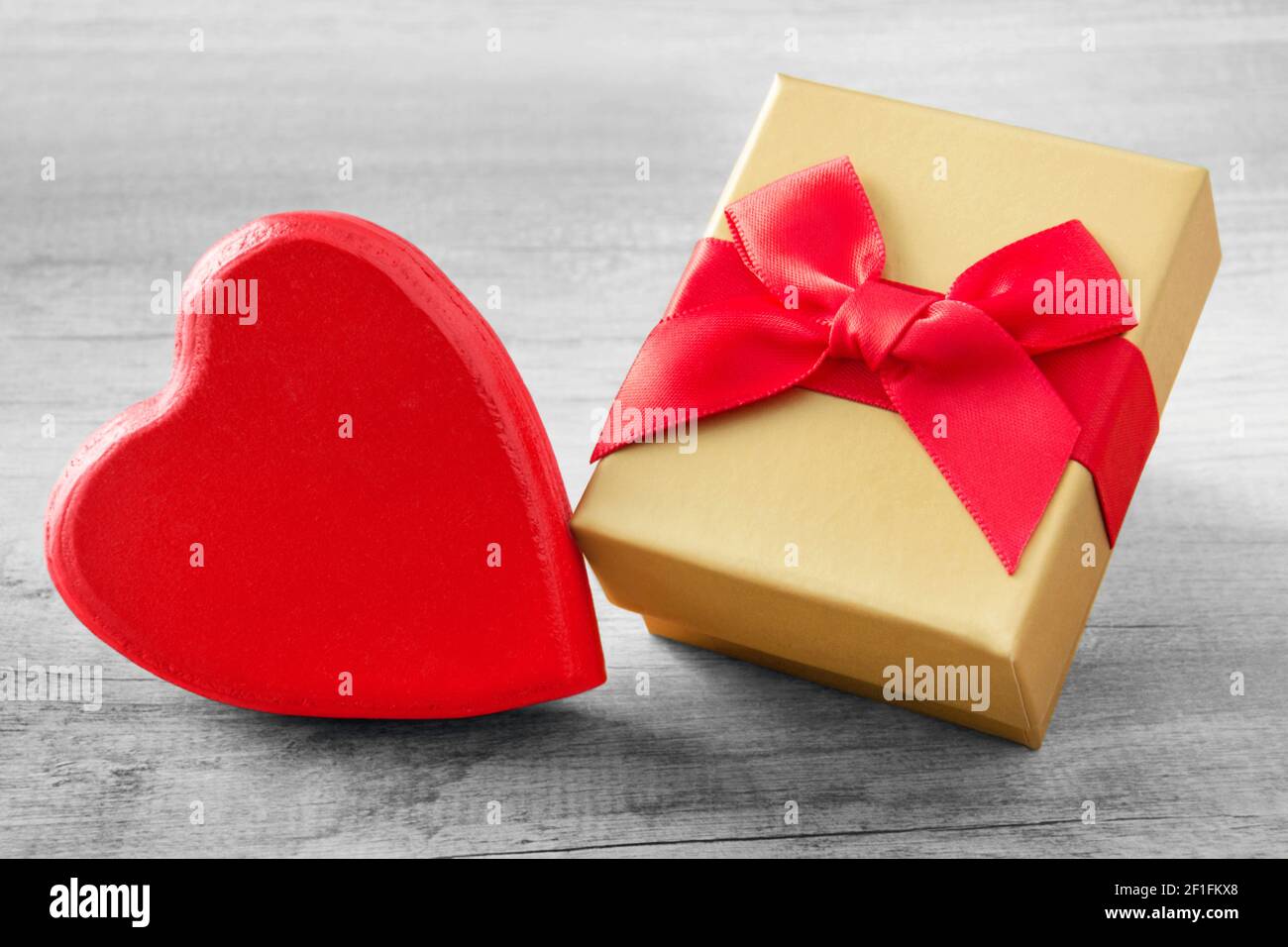 Red heart and golden gift box close up Stock Photo