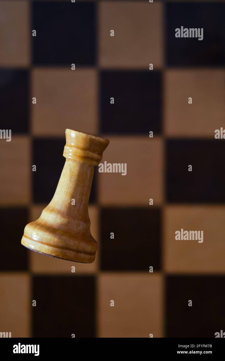 Chess white rook on the background of a retro chessboard from the times ...