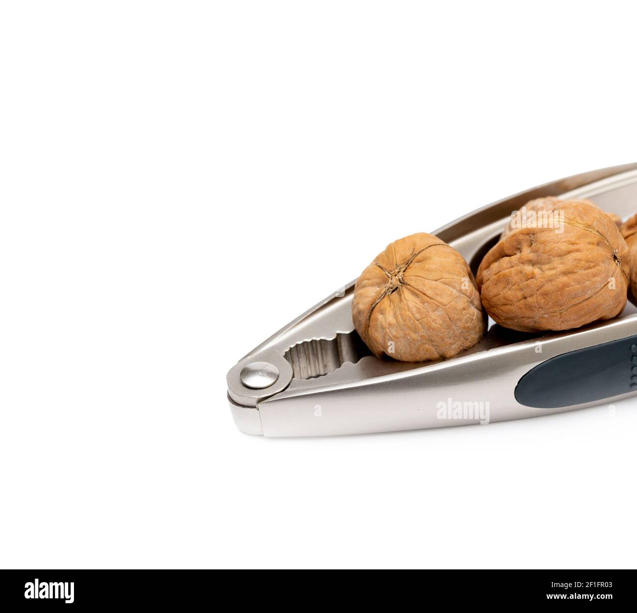 nutcracker and walnuts on white background Stock Photo