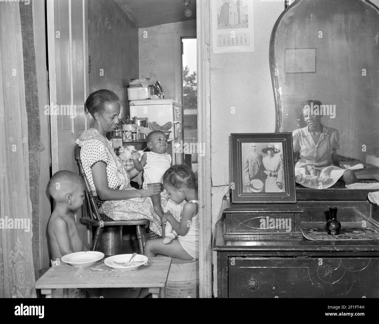 Gordon Parks. Photograph entitled  'Washington, D.C. Mrs. Ella Watson, a government charwoman, with three grandchildren and her adopted daughter'  by Gordon Roger Alexander Buchanan Parks (1912-2006), 1942 Stock Photo