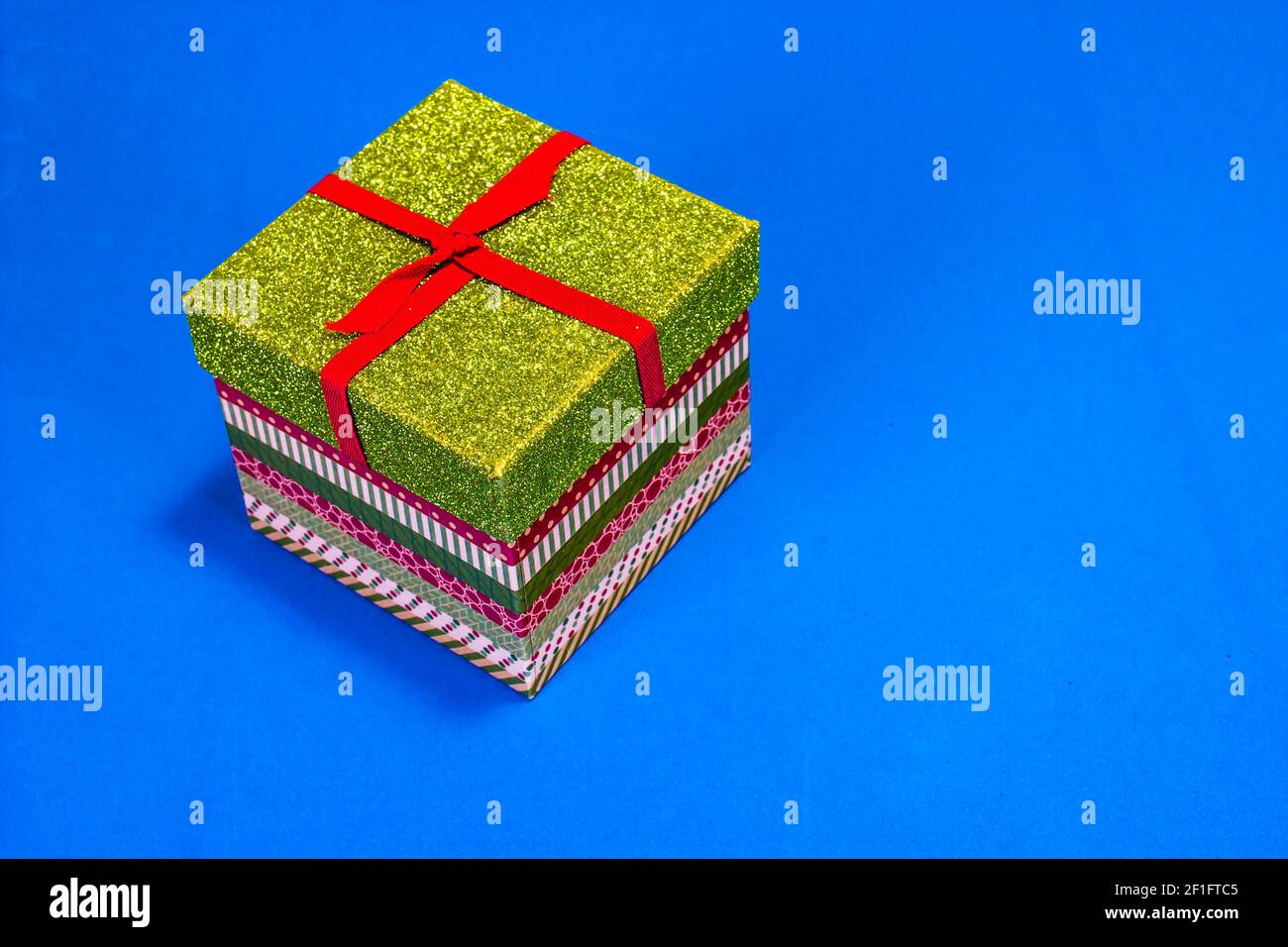 Small Christmas Gift Box On Blue Background Stock Photo