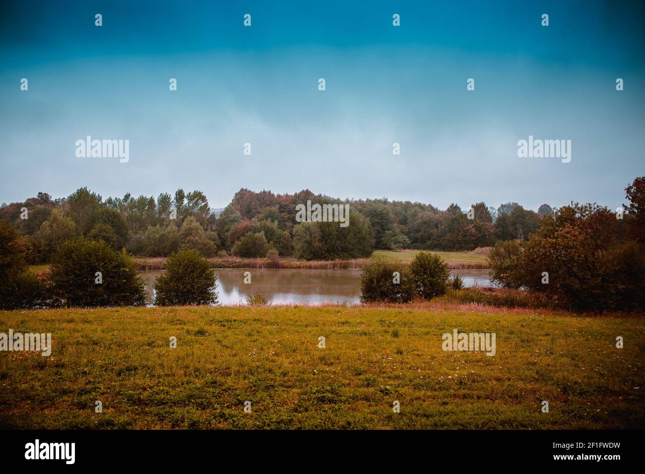 A beautiful shot of a lake in the middle of the forest in autumn Stock ...