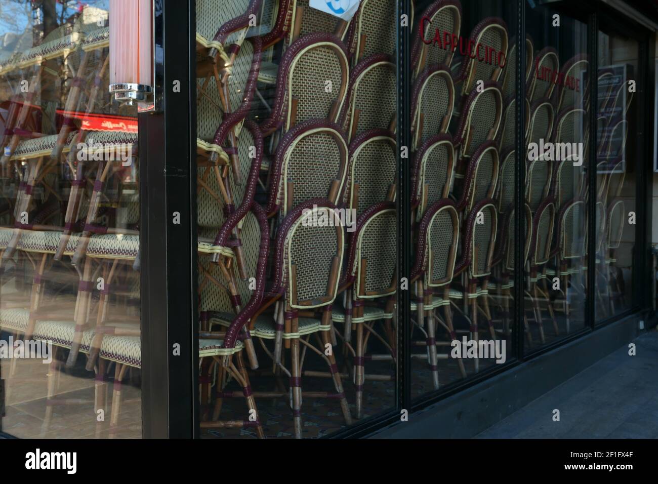 Paris, France. March 07. 2021. Famous restaurant on the Champs-Elysées avenue. Closed business without customers. Chairs stacked in the window. Stock Photo