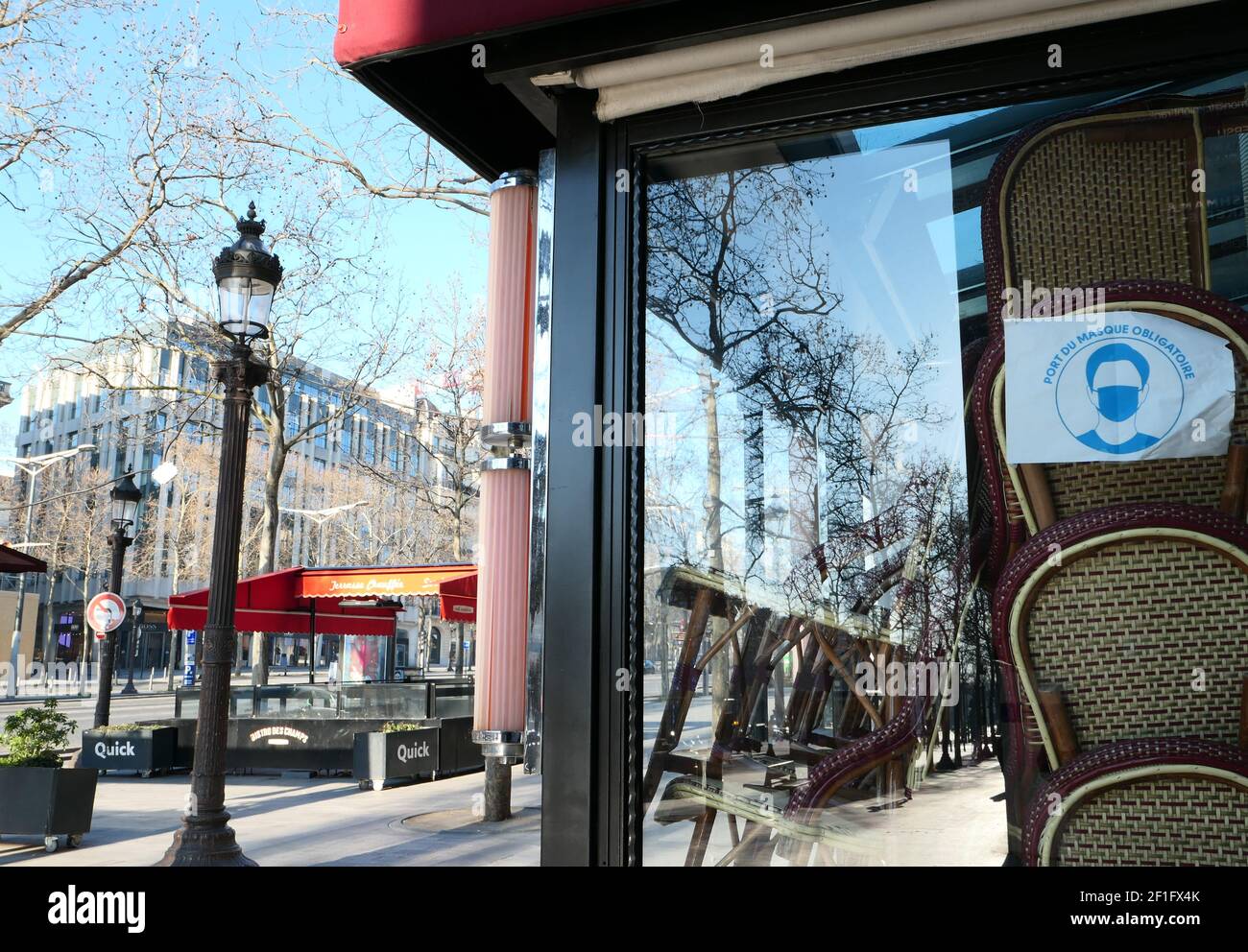 Paris, France. March 07. 2021. Famous restaurant on the Champs-Elysées avenue. Closed business without customers. Chairs stacked in the window. Stock Photo